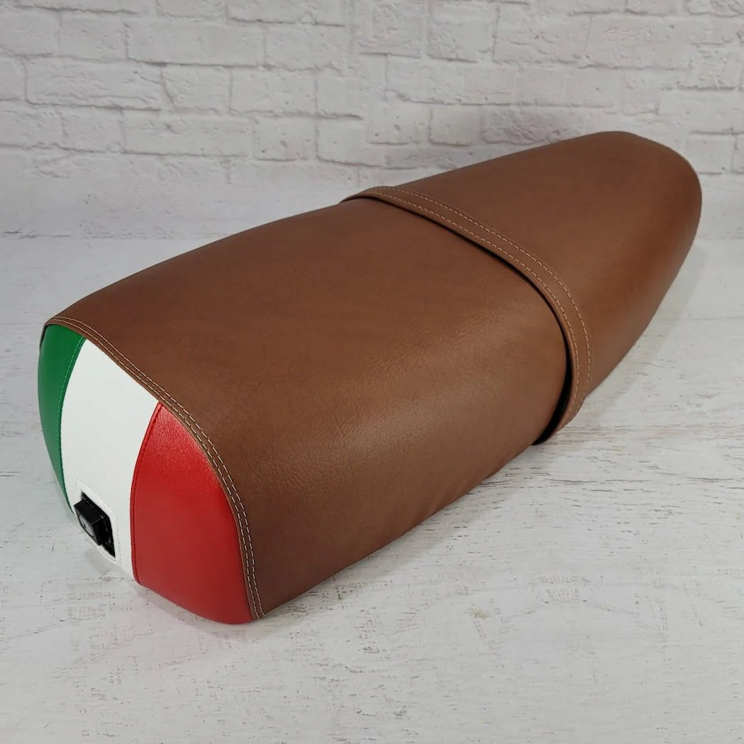 Matte cinnamon Cheeky Seats cover for the Genuine Stella with a hand-sewn Italian flag rear and matching strap