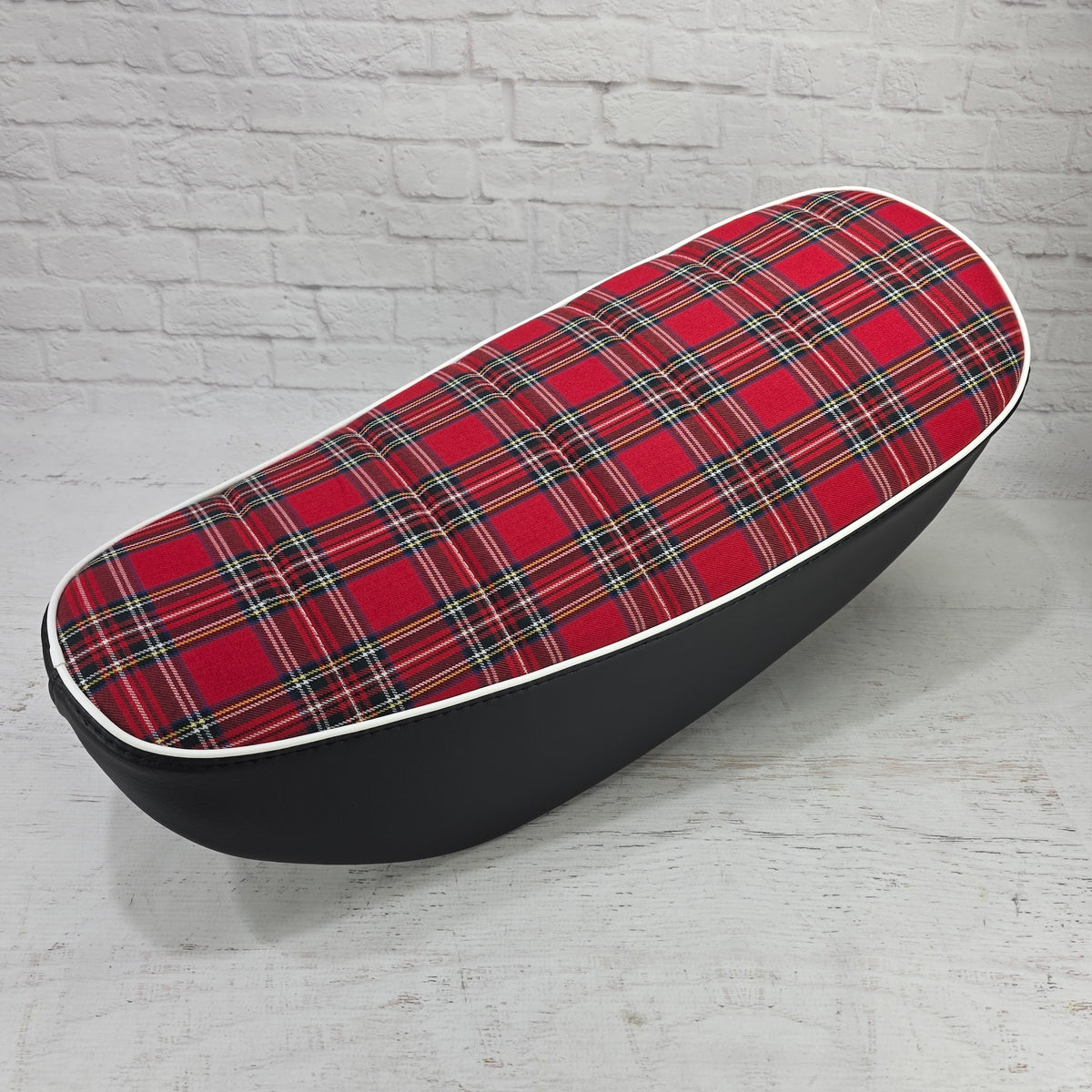 Red tartan plaid tuck-and-roll Honda DAX 125 seat cover with white piping and black sides, handmade by Cheeky Seats