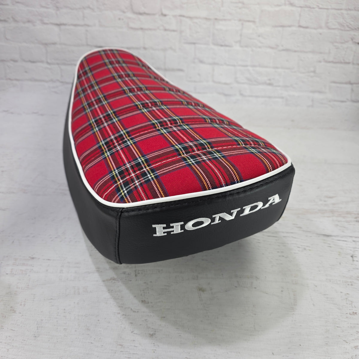 Rear view Honda DAX 125 red tartan plaid seat cover with white piping and a white embroidered Honda logo, handmade by Cheeky Seats
