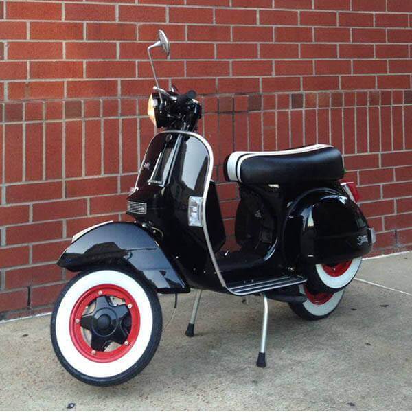 Black Genuine Stella fitted with a Cheeky Seats seat cover featuring hand-sewn white racing stripes