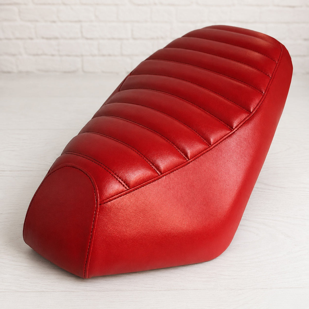 Red padded tuck-and-roll seat cover for Genuine Roughhouse and Rattler, handmade by Cheeky Seats