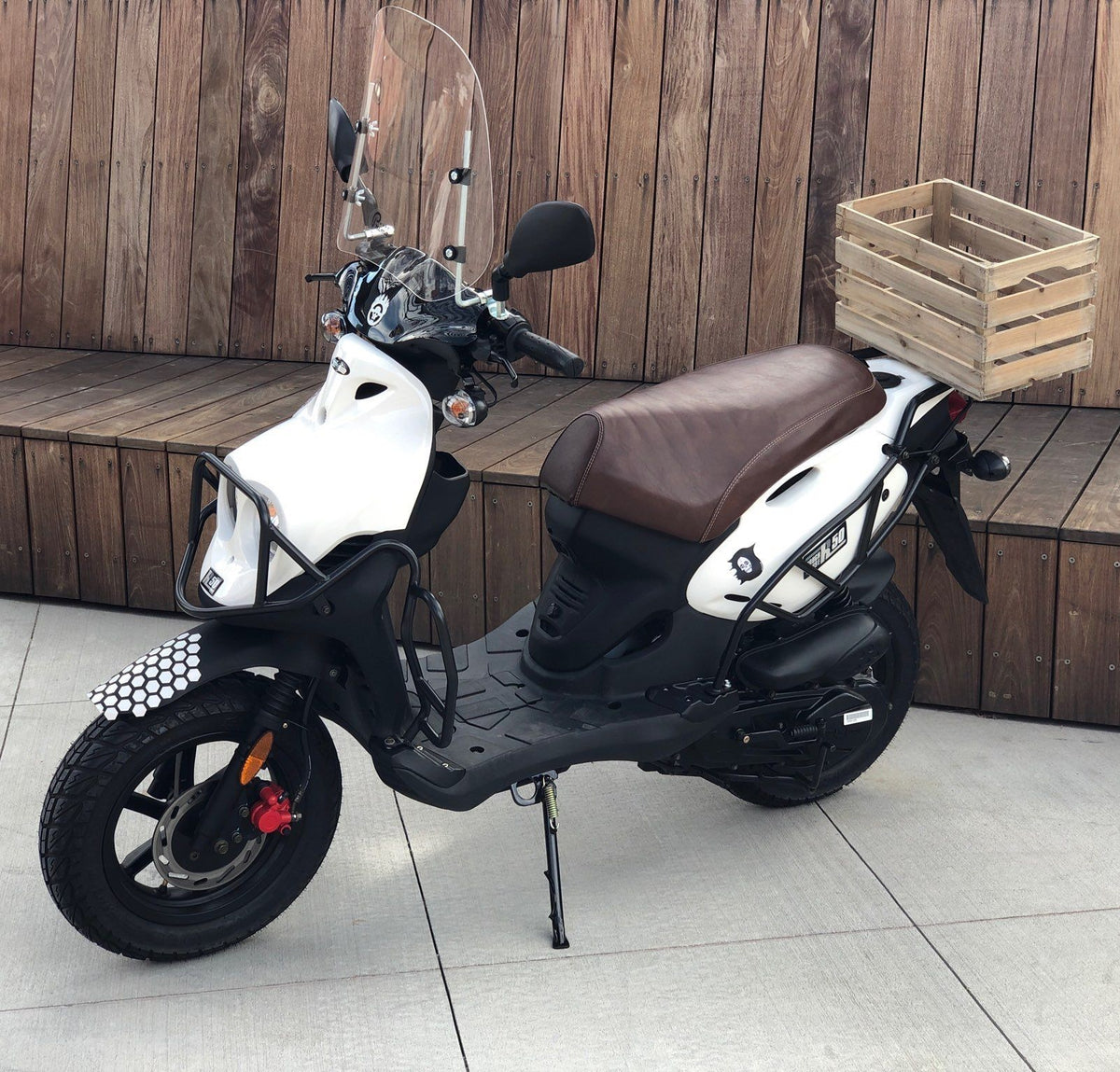 White Genuine Roughhouse 50 Scooter with crate and fitted with a distressed whiskey brown seat cover, handmade by Cheeky Seats