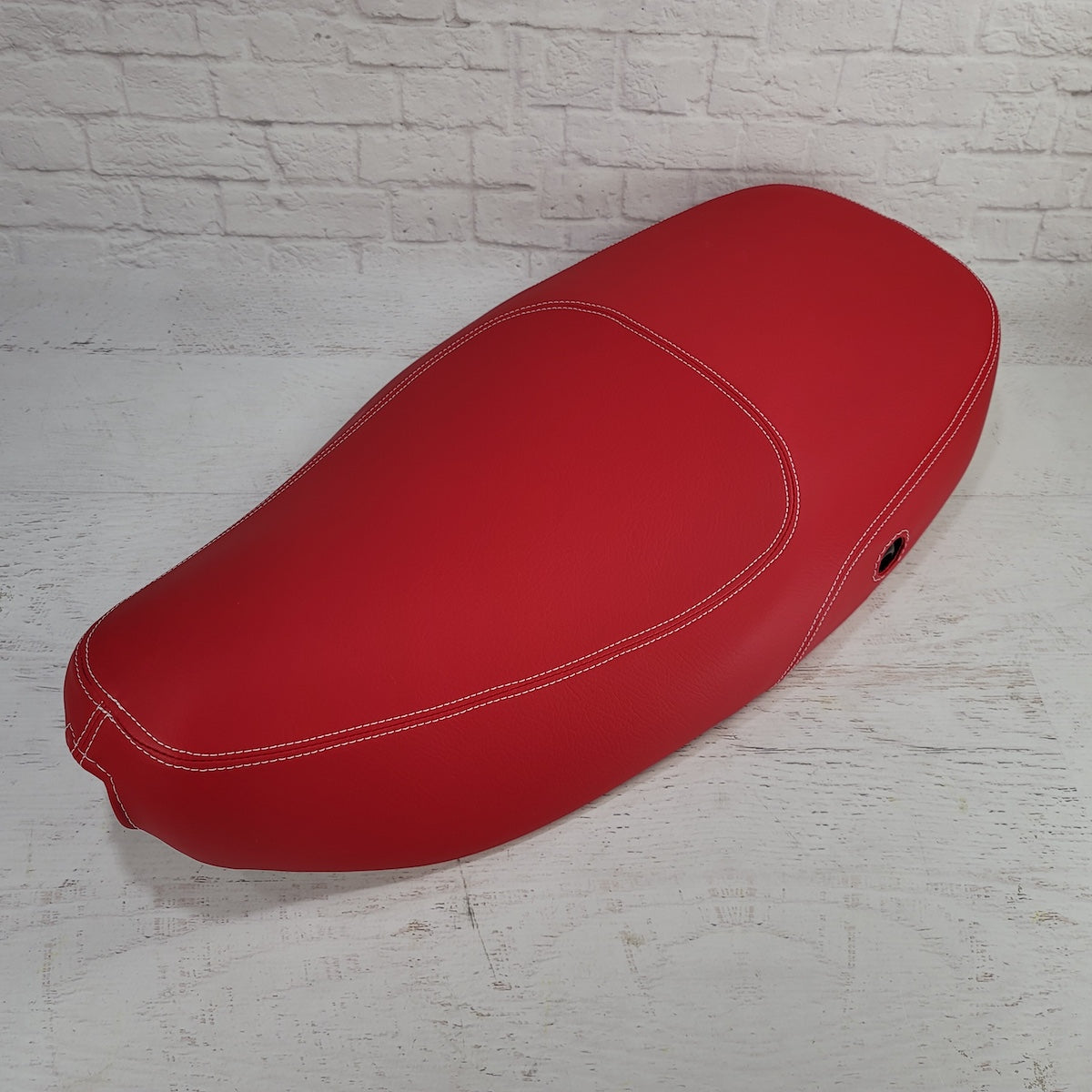 Vespa LX matte red seat cover with French seams