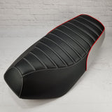 Tuck-and-roll Yamaha Zuma 50 seat cover with a perforated black top, white stitching, red piping and silver rear panel, handmade by Cheeky Seats.