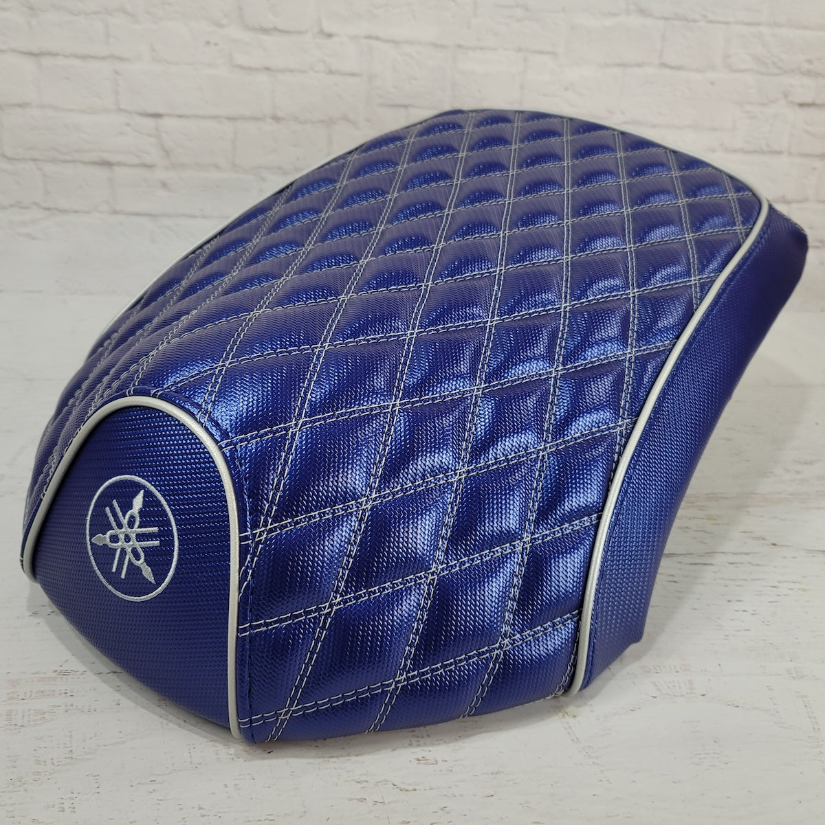 Front three-quarter view of the Blue Carbon Yamaha C3, XF50, Vox and Giggle seat cover with embroidered Yamaha emblem, handmade by Cheeky Seats.
